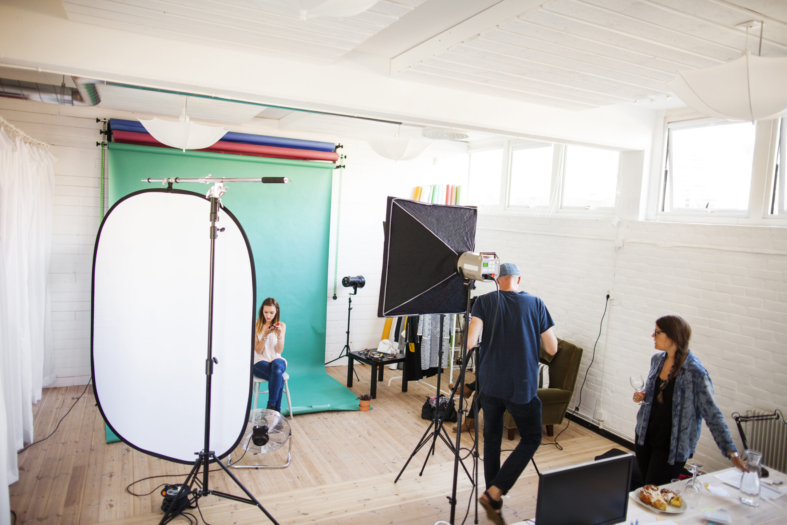 Photographer with assistant and fashion model in studio